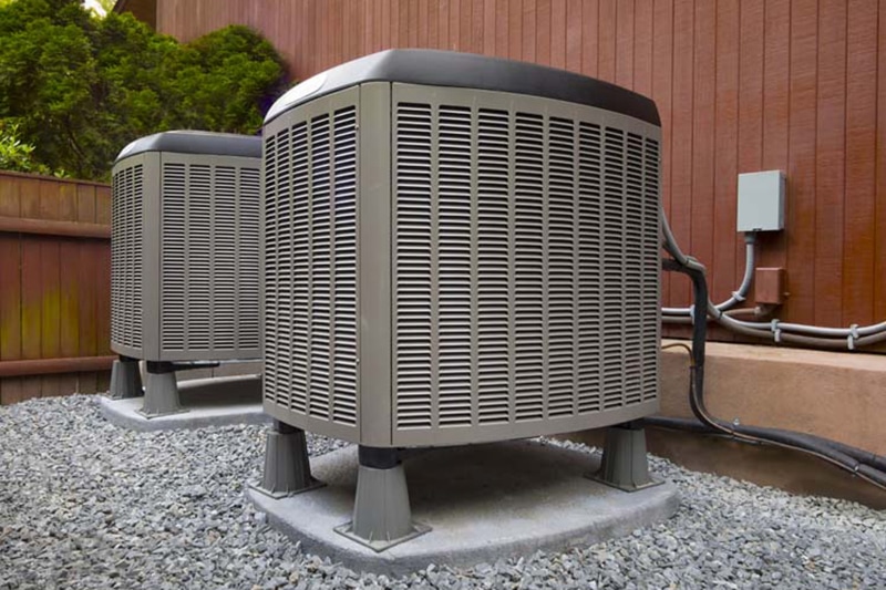 Blog, Know Your AC System. Photo, AC systems outside a house.