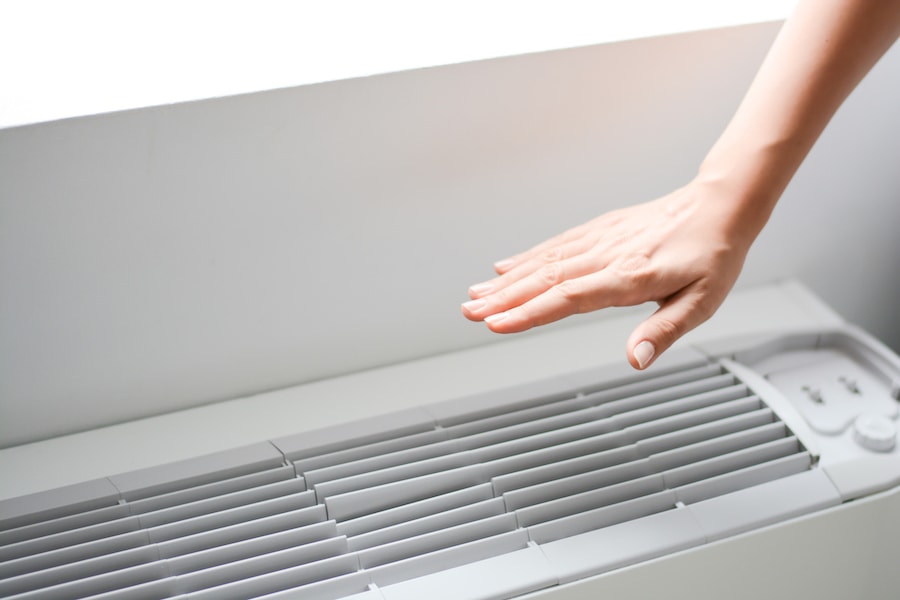 homeowners hand checking to make sure their air conditioner works